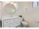 Bathroom featuring a vanity with a round mirror, and a toilet at 4933 E Downing St, Mesa, AZ 85205