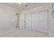 Comfortable bedroom with carpeted floors, a fan, and closet space with doors at 4933 E Downing St, Mesa, AZ 85205