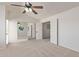Bright bedroom featuring neutral carpet, ceiling fan, and mirrored closet at 4933 E Downing St, Mesa, AZ 85205