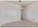 Bedroom with carpeted floors and closet featuring sliding doors, providing practical storage at 4933 E Downing St, Mesa, AZ 85205