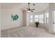 Spacious bedroom featuring a ceiling fan, natural light, and a glass door at 4933 E Downing St, Mesa, AZ 85205