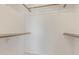 Walk-in closet with hanging racks and shelving to organize clothing and other personal items at 4933 E Downing St, Mesa, AZ 85205