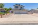 Charming two-story home showcasing a three car garage and desert landscaping at 4933 E Downing St, Mesa, AZ 85205