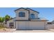 Inviting two-story home with a three car garage and manicured desert landscaping at 4933 E Downing St, Mesa, AZ 85205