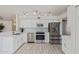 Modern kitchen with stainless steel appliances, white cabinets, and stone backsplash at 4933 E Downing St, Mesa, AZ 85205