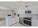 Updated kitchen with stainless steel appliances, sleek lighting, and bright white cabinetry at 4933 E Downing St, Mesa, AZ 85205