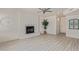 Open living room featuring modern flooring, a cozy fireplace, and ample natural light at 4933 E Downing St, Mesa, AZ 85205