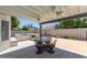 Beautiful covered patio with a built in grill, ceiling fans, and plenty of seating with an inviting outdoor living space at 4933 E Downing St, Mesa, AZ 85205