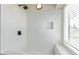 Modern bathroom shower with a black shower head, white marble tiling, and a built-in shower caddy at 4933 E Downing St, Mesa, AZ 85205