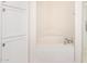 Bathroom showcasing a soaking tub, white cabinets, and tile flooring at 5450 E Deer Valley Dr # 1211, Phoenix, AZ 85054