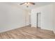 A bright bedroom with hardwood floors, a ceiling fan, and a closet with white sliding doors at 5450 E Deer Valley Dr # 1211, Phoenix, AZ 85054