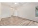 Bright bedroom features wood-style flooring, white walls, and a large window at 5450 E Deer Valley Dr # 1211, Phoenix, AZ 85054