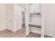 Hallway with a built-in desk, cabinets, shelving, and modern wood-style flooring at 5450 E Deer Valley Dr # 1211, Phoenix, AZ 85054