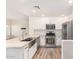 Well-lit kitchen featuring stainless steel appliances, ample counter space, and white cabinets at 5450 E Deer Valley Dr # 1211, Phoenix, AZ 85054