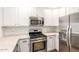 An efficient kitchen featuring stainless steel appliances, white cabinets, and light countertops at 5450 E Deer Valley Dr # 1211, Phoenix, AZ 85054