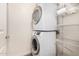 Convenient laundry room featuring stacked washer and dryer and wire shelving at 5450 E Deer Valley Dr # 1211, Phoenix, AZ 85054