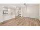 Light filled living room blending with kitchen, featuring stainless appliances and wood floors at 5450 E Deer Valley Dr # 1211, Phoenix, AZ 85054