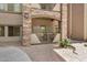 Exterior view of patio with stone facade and landscaped gravel area at 5450 E Deer Valley Dr # 1211, Phoenix, AZ 85054