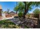 Private backyard space featuring lush greenery, mature trees, a hot tub, and patio area at 647 W Mission Dr, Chandler, AZ 85225