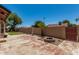 An enclosed backyard with a fire pit, lush landscaping, and access gate to the back alley at 647 W Mission Dr, Chandler, AZ 85225