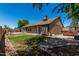 A well-manicured backyard with a small lawn, patio area, and access to outdoor kitchen area at 647 W Mission Dr, Chandler, AZ 85225