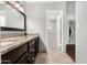 Bathroom with granite double vanity, dark wood cabinets and an adjoining shower room at 647 W Mission Dr, Chandler, AZ 85225