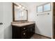 Bright bathroom features a dark wood vanity with granite countertops, mirror, and tile floors at 647 W Mission Dr, Chandler, AZ 85225