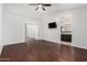 Bedroom with wood floors, ceiling fan and a television mounted on the wall at 647 W Mission Dr, Chandler, AZ 85225