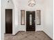 Welcoming entryway with tiled flooring, decorative lighting, and a front door with glass detailing at 647 W Mission Dr, Chandler, AZ 85225
