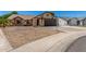 Charming single-story home with a two-car garage, rock landscaping, and a well-maintained front yard at 647 W Mission Dr, Chandler, AZ 85225