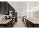 Modern kitchen with dark cabinets, stainless steel appliances, granite countertops, and stylish backsplash at 647 W Mission Dr, Chandler, AZ 85225
