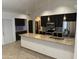 This open kitchen features modern appliances, granite countertops, and beautiful pendant lighting at 647 W Mission Dr, Chandler, AZ 85225