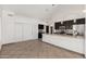 Spacious kitchen with dark cabinets, tiled flooring, stainless steel appliances, and a breakfast bar at 647 W Mission Dr, Chandler, AZ 85225