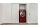 Modern laundry closet features a bright red washer and dryer for your convenience at 647 W Mission Dr, Chandler, AZ 85225