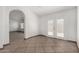 Open living room with tile flooring, an archway, and access to the backyard through glass doors at 647 W Mission Dr, Chandler, AZ 85225