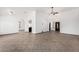 Open living room featuring tile floors, arched doorways, neutral walls, and a ceiling fan at 647 W Mission Dr, Chandler, AZ 85225