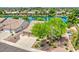 Aerial shot of a home with a well-manicured yard near a beautiful lake in a residential neighborhood at 694 W Beechnut Dr, Chandler, AZ 85248