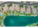Scenic aerial of waterfront homes with pools and lush greenery, set against a backdrop of blue skies and water at 694 W Beechnut Dr, Chandler, AZ 85248