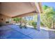 Inviting covered patio with views of the landscaped yard and a glimpse of mature palm trees at 694 W Beechnut Dr, Chandler, AZ 85248