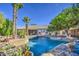 Inviting backyard oasis featuring a sparkling pool, lush tropical landscaping, and a serene outdoor living space at 694 W Beechnut Dr, Chandler, AZ 85248