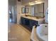 Luxurious bathroom featuring dual sinks, a large mirror, vanity area, and a separate soaking tub at 694 W Beechnut Dr, Chandler, AZ 85248