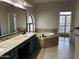 Bathroom featuring tub and granite countertop with vanity at 694 W Beechnut Dr, Chandler, AZ 85248