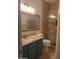 Bathroom featuring granite countertop and shower with glass doors at 694 W Beechnut Dr, Chandler, AZ 85248