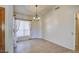 Bright bedroom with light tile floors, sheer curtains, a chandelier, and neutral walls creating a serene atmosphere at 694 W Beechnut Dr, Chandler, AZ 85248