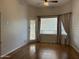 Bedroom featuring wood floors, ceiling fan and door to the patio at 694 W Beechnut Dr, Chandler, AZ 85248