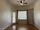 Bedroom featuring wood floors, ceiling fan and door to the patio at 694 W Beechnut Dr, Chandler, AZ 85248