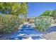 Home entrance with stepped walkway through lush greenery, providing a serene and inviting approach to the property at 694 W Beechnut Dr, Chandler, AZ 85248