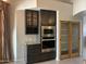 Well-equipped kitchen with built-in oven, microwave, wine storage, granite countertops and glass-paneled display cabinets at 694 W Beechnut Dr, Chandler, AZ 85248