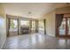 Spacious living room with tiled floors, fireplace, and natural light pouring through large windows with beautiful backyard views at 694 W Beechnut Dr, Chandler, AZ 85248