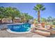 Backyard pool featuring a stone-lined edge, mature landscaping, and a tranquil water feature at 694 W Beechnut Dr, Chandler, AZ 85248